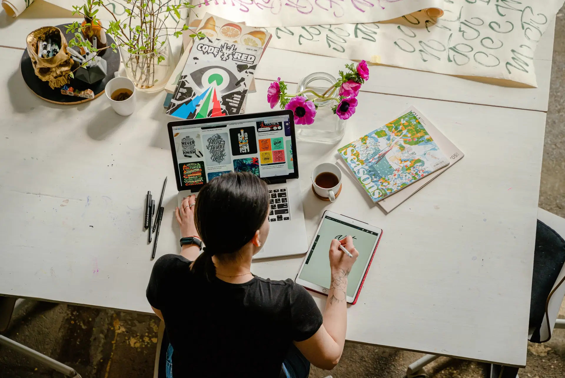 overhead view of person sketching at table of art supples, showing how anxiety and creativity can be connected