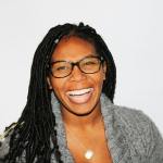 black woman in gray sweater wearing glasses, happy to overcome a phobia